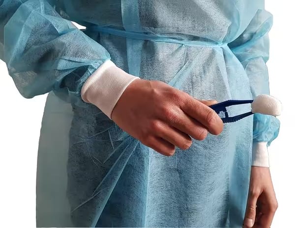 Isolation gown with cotton cuffs